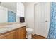 Well-lit bathroom featuring a shower, a wood vanity, and a toilet, perfect for everyday use at 171 Nacoochee Way, Canton, GA 30114