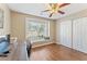 Bright bedroom with a cozy window seat, wood floors, and a spacious closet, perfect for relaxation and storage at 171 Nacoochee Way, Canton, GA 30114
