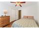 Bright bedroom featuring wood floors, a ceiling fan, and a spacious closet for ample storage at 171 Nacoochee Way, Canton, GA 30114