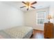 Comfortable bedroom featuring wood floors, a ceiling fan, a window, and a chest of drawers at 171 Nacoochee Way, Canton, GA 30114