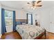 Inviting bedroom with wood floors, ceiling fan, natural light, and easy access to the en-suite bathroom at 171 Nacoochee Way, Canton, GA 30114