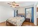 Cozy bedroom with wood floors, ceiling fan, natural light, and calming blue curtains for a restful atmosphere at 171 Nacoochee Way, Canton, GA 30114