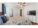Comfortable bedroom with wood floors, a ceiling fan, a TV, and plenty of storage space for relaxation at 171 Nacoochee Way, Canton, GA 30114