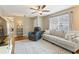 Inviting living room featuring a ceiling fan, stylish furniture, and a bright window for natural light at 171 Nacoochee Way, Canton, GA 30114