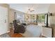 Open-concept living room with hardwood floors, a fan, and access to the backyard through sliding glass doors at 171 Nacoochee Way, Canton, GA 30114