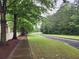 Scenic walking path meandering through the community, lined with mature trees and lush greenery at 171 Nacoochee Way, Canton, GA 30114