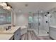 Well-lit bathroom featuring a glass shower, soaking tub, and vanity with gray cabinets at 178 Mission Oak Dr, Grayson, GA 30017