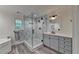 Renovated bathroom with a glass shower, gray cabinets, and stylish fixtures at 178 Mission Oak Dr, Grayson, GA 30017