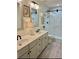 Modern bathroom with double sink vanity and a large glass-enclosed walk-in shower at 178 Mission Oak Dr, Grayson, GA 30017