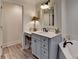 Well-lit bathroom featuring a vanity with gray cabinets and a soaking tub at 178 Mission Oak Dr, Grayson, GA 30017