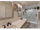 Modern bathroom features a double sink vanity and a tiled shower with glass doors at 178 Mission Oak Dr, Grayson, GA 30017