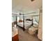 Spacious main bedroom with four poster bed, tray ceiling, and comfortable sitting area at 178 Mission Oak Dr, Grayson, GA 30017