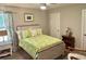 Cozy bedroom featuring a wooden bed frame and bright floral comforter at 178 Mission Oak Dr, Grayson, GA 30017