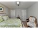 Bright bedroom features neutral walls, a ceiling fan, and a bed with a green and white floral comforter at 178 Mission Oak Dr, Grayson, GA 30017