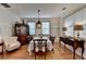 Traditional dining room featuring hardwood floors and antique furnishings, illuminated by a hanging light fixture at 178 Mission Oak Dr, Grayson, GA 30017