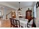 Bright dining room with hardwood floors and a staircase visible in the background at 178 Mission Oak Dr, Grayson, GA 30017