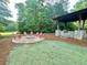 Outdoor fire pit area with seating and a covered outdoor kitchen at 178 Mission Oak Dr, Grayson, GA 30017