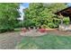 Picturesque outdoor stone fire pit surrounded by Adirondack chairs, perfect for entertaining in your private backyard at 178 Mission Oak Dr, Grayson, GA 30017