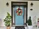 A welcoming front door adorned with a wreath and flanked by plants, creating a charming entrance at 178 Mission Oak Dr, Grayson, GA 30017