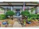Inviting front porch with patriotic decor, a colorful door wreath, and well-manicured landscaping at 178 Mission Oak Dr, Grayson, GA 30017