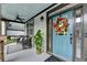 Inviting front porch with comfortable seating, a stylish blue front door, and green plants at 178 Mission Oak Dr, Grayson, GA 30017