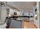 Bright, modern kitchen with white cabinets, black counters, stainless steel appliances, and hardwood floors at 178 Mission Oak Dr, Grayson, GA 30017