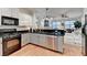 Modern kitchen featuring stainless appliances, black countertops and a view to the living room at 178 Mission Oak Dr, Grayson, GA 30017