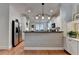 Kitchen with stainless steel refrigerator, white cabinets, and hardwood floors at 178 Mission Oak Dr, Grayson, GA 30017