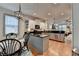 Open kitchen featuring white cabinets, black countertops and island with views to the living room at 178 Mission Oak Dr, Grayson, GA 30017