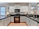Well-lit kitchen with white cabinets, stainless sink and appliances, and a subway tile backsplash at 178 Mission Oak Dr, Grayson, GA 30017