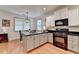 Modern kitchen with black countertop island and stainless steel appliances at 178 Mission Oak Dr, Grayson, GA 30017