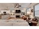 Living room with fireplace, white couch, and open layout connecting to kitchen at 178 Mission Oak Dr, Grayson, GA 30017