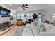 Cozy living room with fireplace, plush white sofa, ceiling fan, and natural light from windows at 178 Mission Oak Dr, Grayson, GA 30017