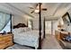 Relaxing main bedroom with a canopy bed, tray ceiling, and ensuite bathroom access at 178 Mission Oak Dr, Grayson, GA 30017