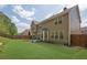 Large backyard with green lawn and privacy fence and house with many windows at 3133 Bridge Walk Dr, Lawrenceville, GA 30044