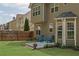 Backyard patio seating area with green lawn and beautiful, new neutral colored siding at 3133 Bridge Walk Dr, Lawrenceville, GA 30044