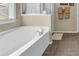 Bathroom with a tub and shower with neutral walls and decor at 3133 Bridge Walk Dr, Lawrenceville, GA 30044