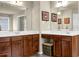 Bathroom with dual sinks, wood cabinets, white countertops and decor at 3133 Bridge Walk Dr, Lawrenceville, GA 30044