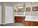 Bathroom with wood cabinets, white countertops, and stylish decor at 3133 Bridge Walk Dr, Lawrenceville, GA 30044