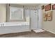 Bathroom featuring a modern bathtub and glass-enclosed shower at 3133 Bridge Walk Dr, Lawrenceville, GA 30044