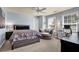 Comfortable bedroom featuring carpet, light blue walls, ceiling fan and accent seating at 3133 Bridge Walk Dr, Lawrenceville, GA 30044