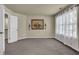Bedroom with neutral walls and carpet, large window and stairway access at 3133 Bridge Walk Dr, Lawrenceville, GA 30044