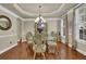 Bright dining room featuring a glass table, stylish chairs, and beautiful lighting fixtures at 3133 Bridge Walk Dr, Lawrenceville, GA 30044