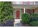 Charming home entrance featuring a welcoming red front door and well-maintained landscaping at 3133 Bridge Walk Dr, Lawrenceville, GA 30044