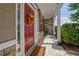 Inviting front porch with a red door and decorative wreath, offering a warm welcome at 3133 Bridge Walk Dr, Lawrenceville, GA 30044