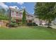 Charming two-story home with a well-manicured lawn, complemented by lush landscaping and red shutters at 3133 Bridge Walk Dr, Lawrenceville, GA 30044