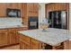 Close up of kitchen island with granite countertops, stainless appliances and wood cabinets at 3133 Bridge Walk Dr, Lawrenceville, GA 30044