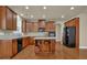 Spacious kitchen with wooden cabinets, a center island, stainless steel appliances, and hardwood floors at 3133 Bridge Walk Dr, Lawrenceville, GA 30044