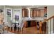 Eat-in kitchen features wooden cabinets, hardwood floors, stainless steel appliances, and natural light at 3133 Bridge Walk Dr, Lawrenceville, GA 30044