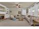 Inviting living room features a stone fireplace, built-in shelving, and a ceiling fan for added comfort at 3133 Bridge Walk Dr, Lawrenceville, GA 30044